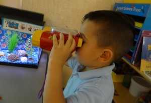 preschooler with red binoculars